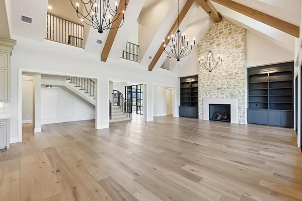 wooden floor in an empty room with a fireplace