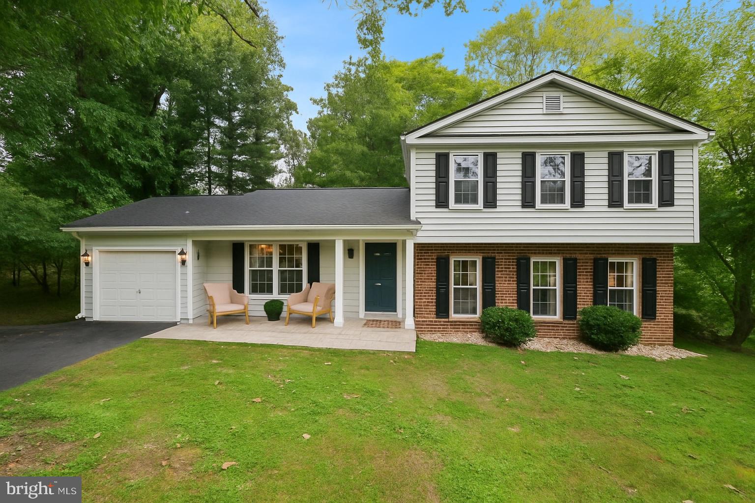 a front view of a house with a garden and porch