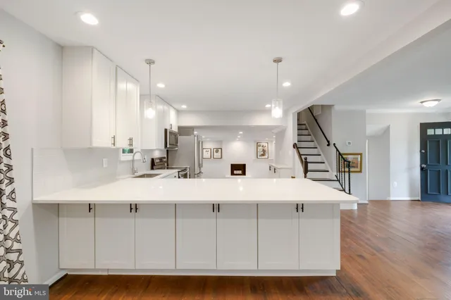 a view of kitchen with wooden floor and window