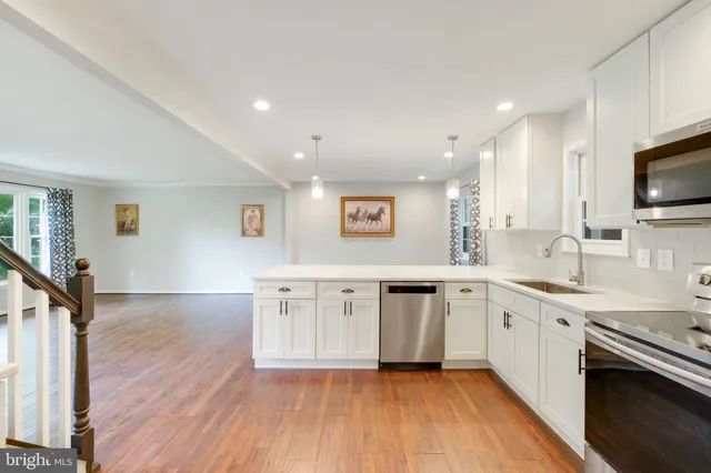 a kitchen with stainless steel appliances granite countertop a refrigerator sink and stove