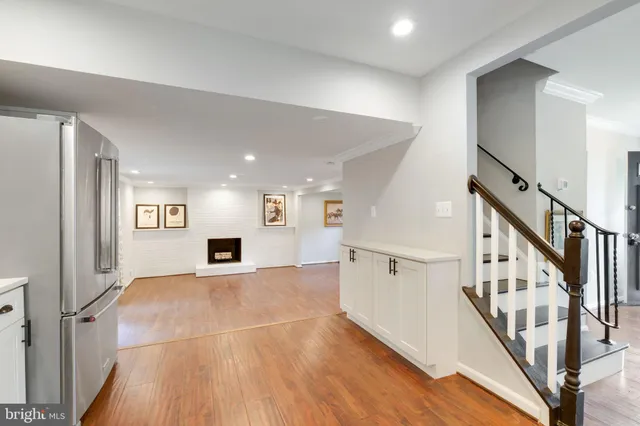 a large kitchen with stainless steel appliances granite countertop a sink and cabinets