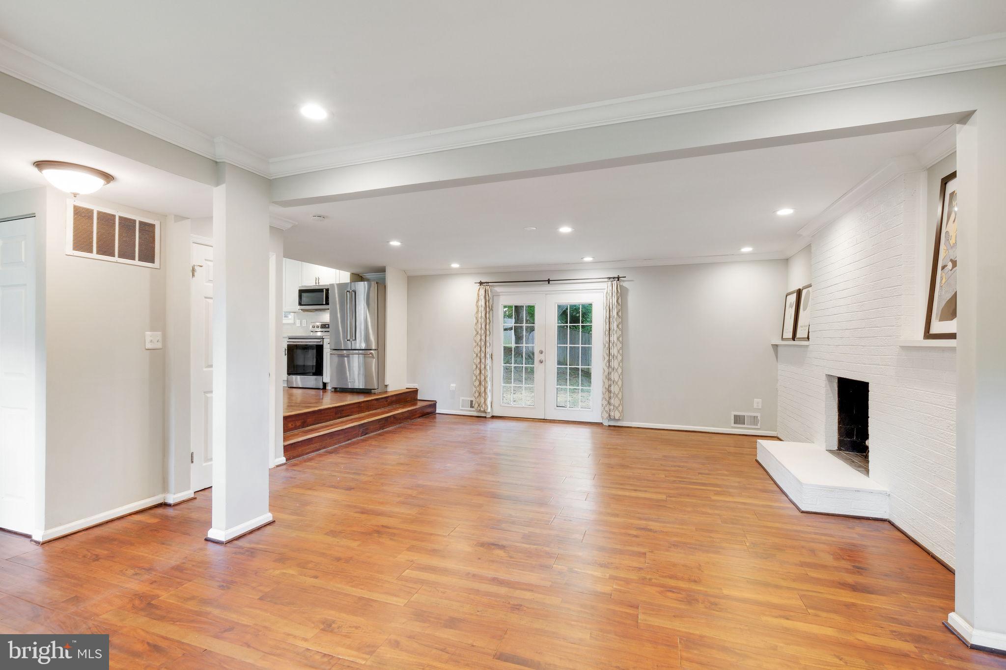 5 Winesap Court Gaithersburg, MD 20878 - Photo 21 of 44 a view of empty room with wooden floor and fireplace