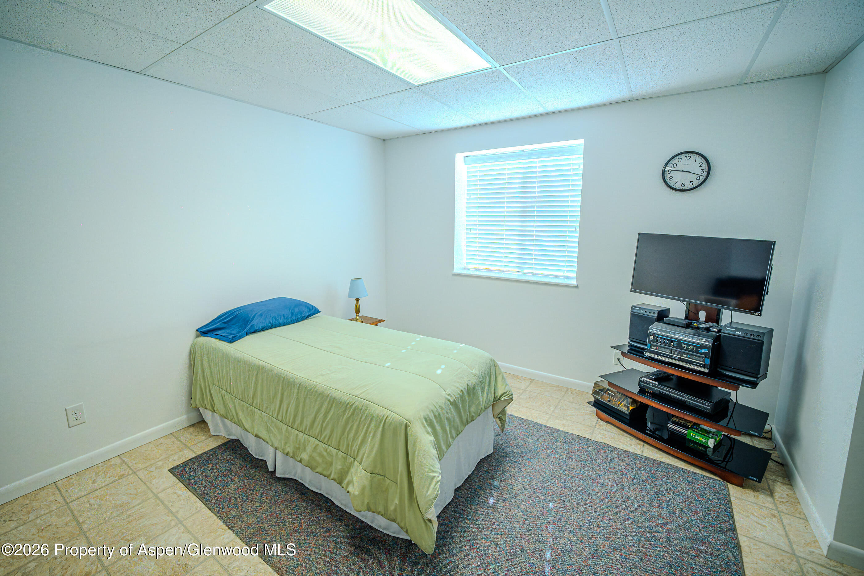 2319 Meadow Circle Rifle, CO 81650 - Photo 12 of 33 a bedroom with a bed and a flat screen tv