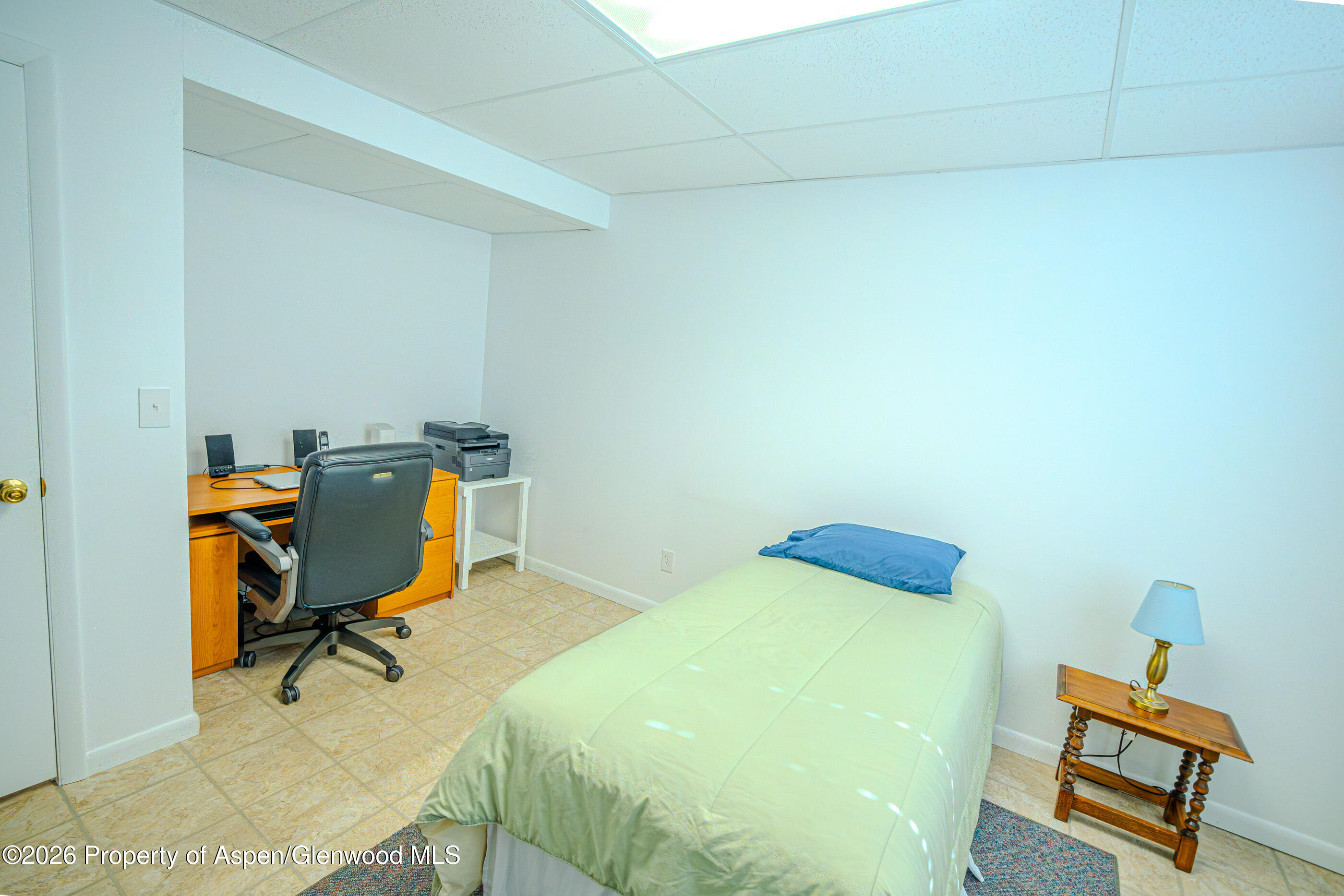 2319 Meadow Circle Rifle, CO 81650 - Photo 13 of 33 a bedroom with a bed and a desk in it