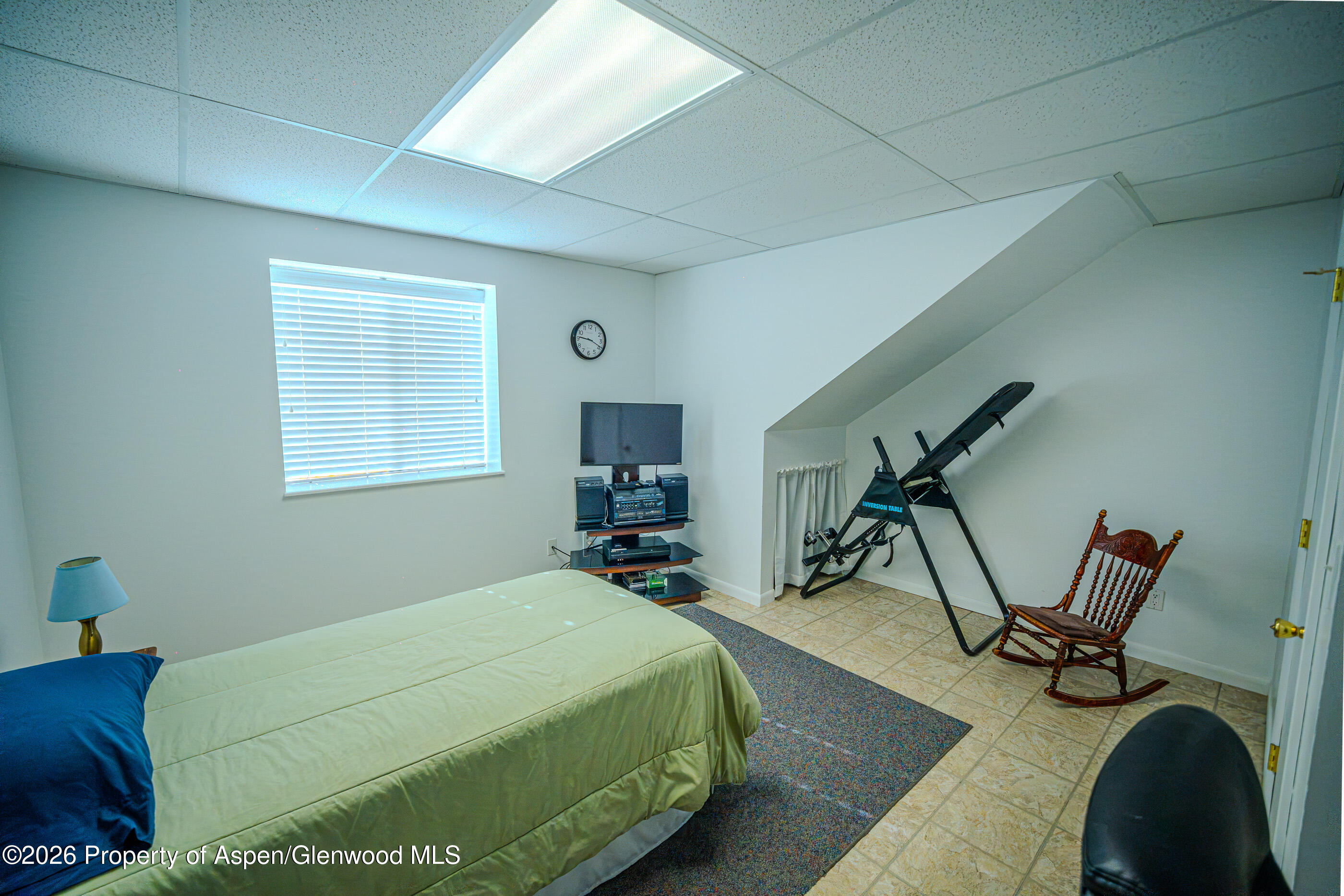 2319 Meadow Circle Rifle, CO 81650 - Photo 14 of 33 a bedroom with a bed and wooden floor