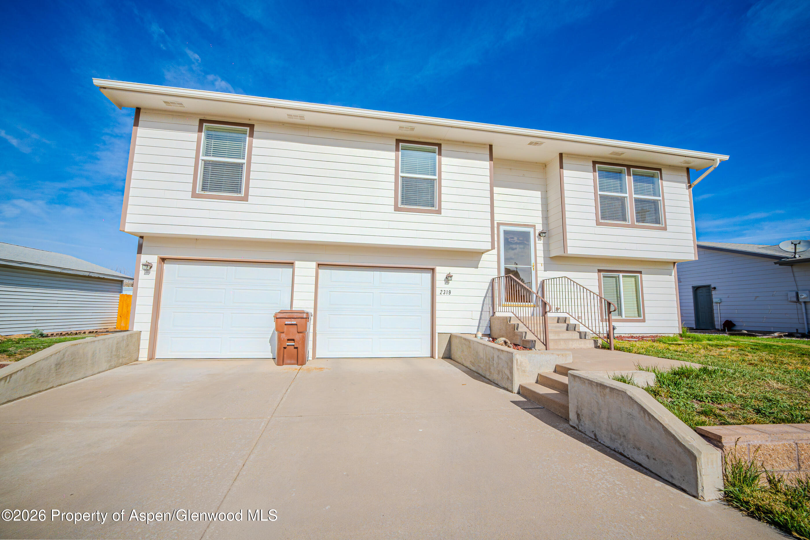 2319 Meadow Circle Rifle, CO 81650 - Photo 2 of 33 a front view of a house with garden
