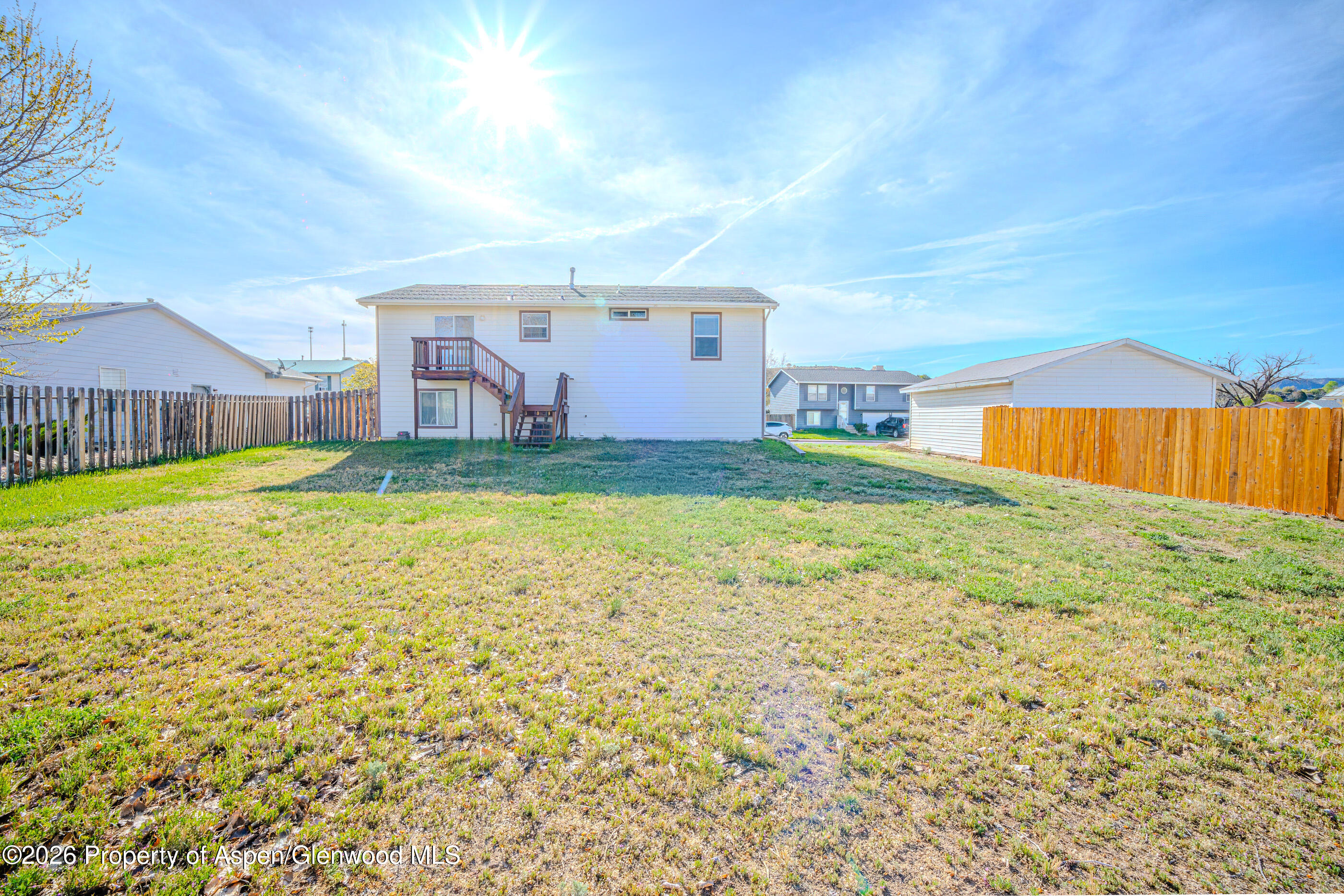 2319 Meadow Circle Rifle, CO 81650 - Photo 21 of 33 a view of a house with a yard and a garden