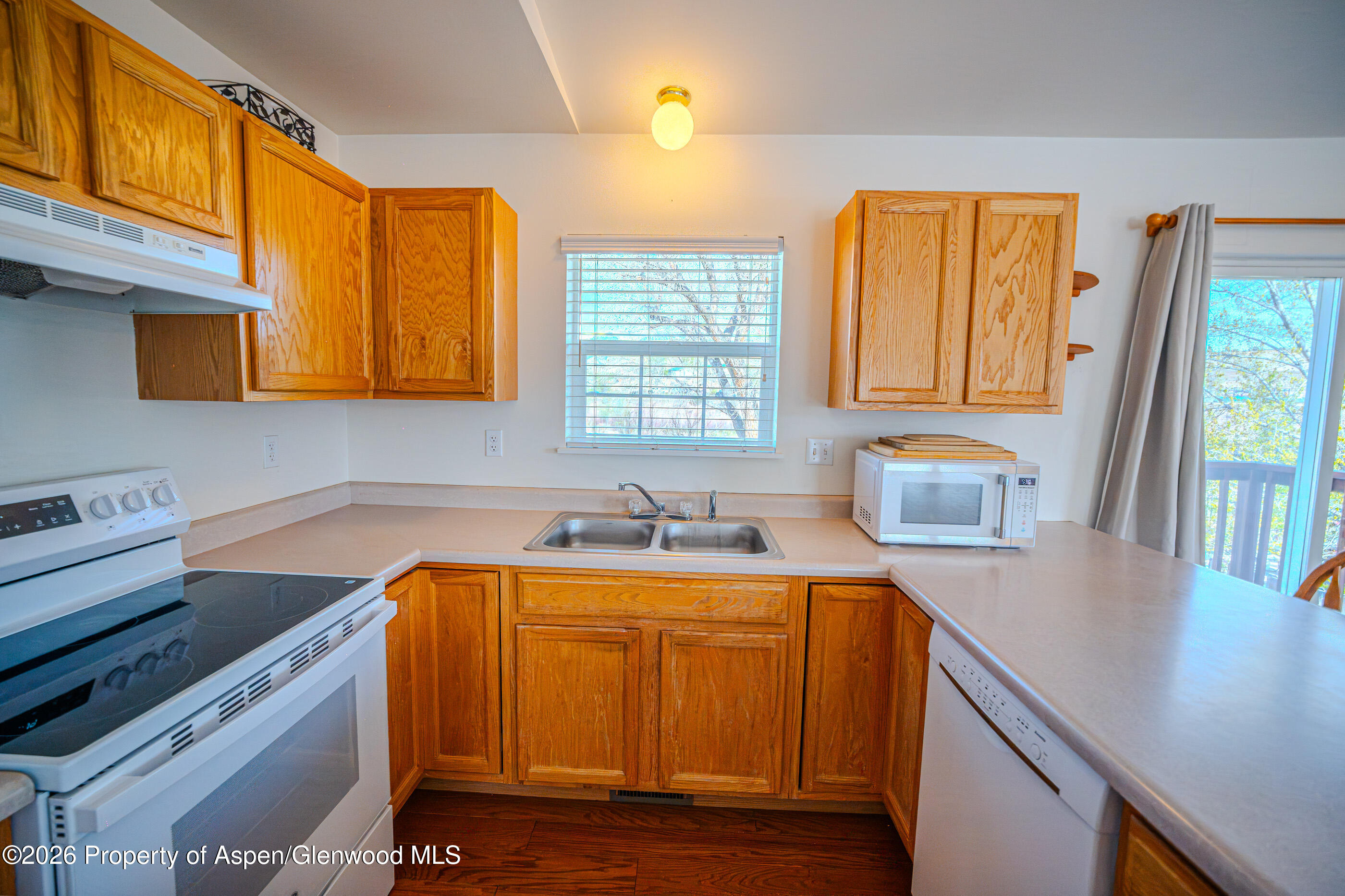 2319 Meadow Circle Rifle, CO 81650 - Photo 3 of 33 a kitchen with a sink a window and cabinets