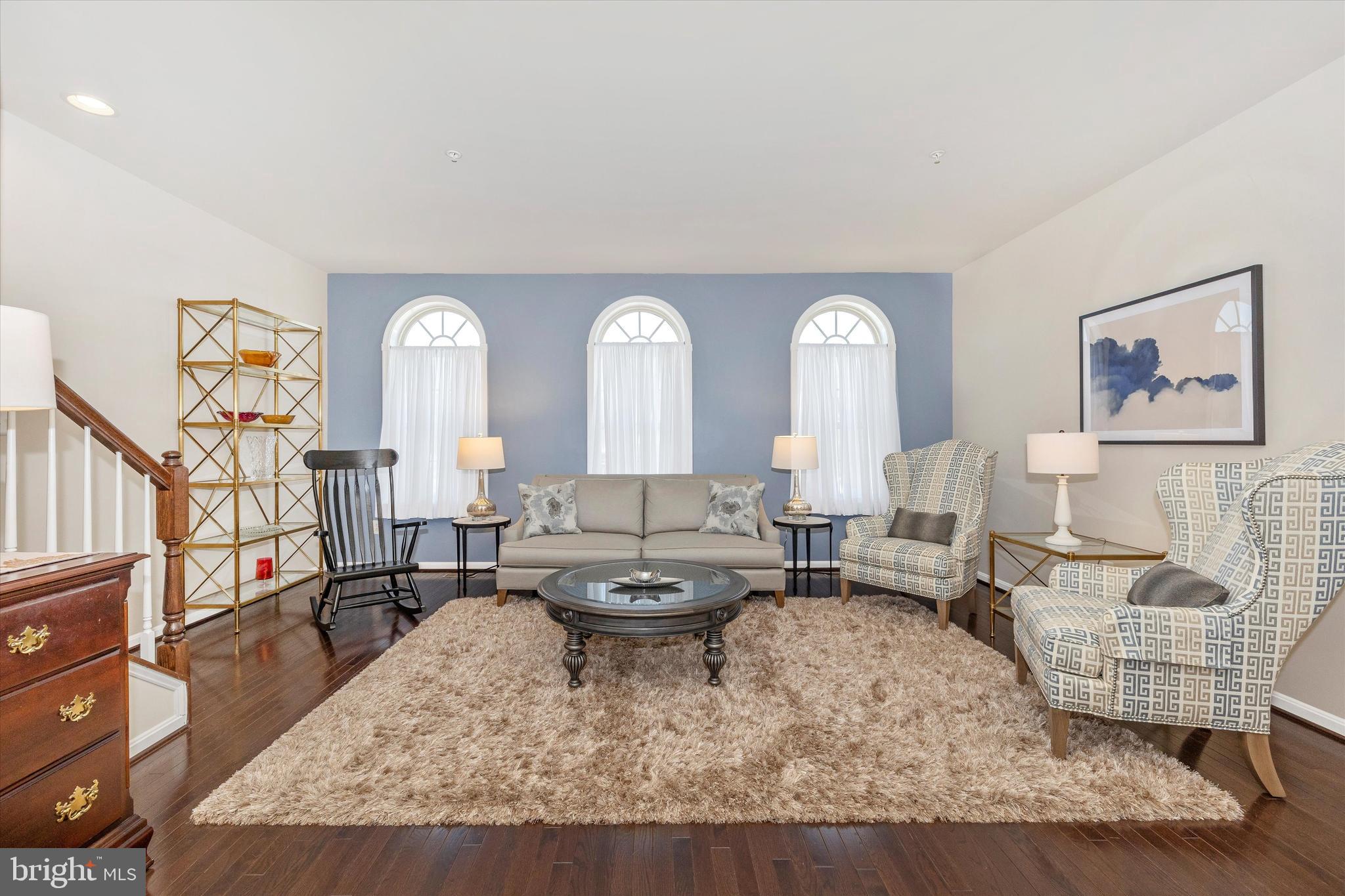 4731 Verdana Loop Frederick, MD 21703 - Photo 13 of 51 a living room with couches and a large mirror with wooden floor