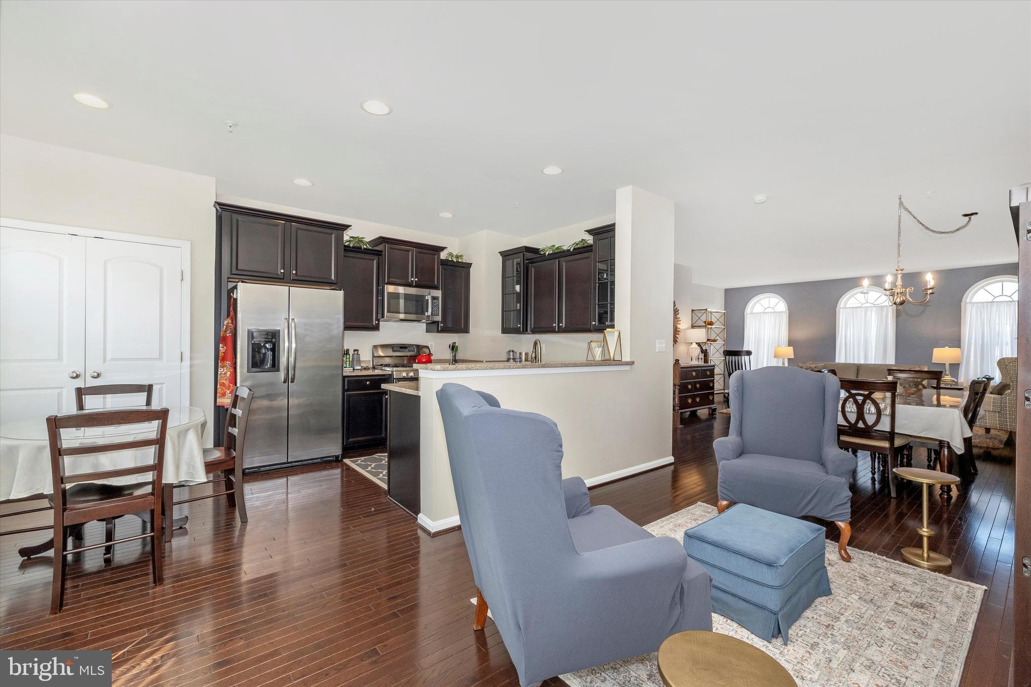 4731 Verdana Loop Frederick, MD 21703 - Photo 16 of 51 a living room with furniture kitchen view and a wooden floor