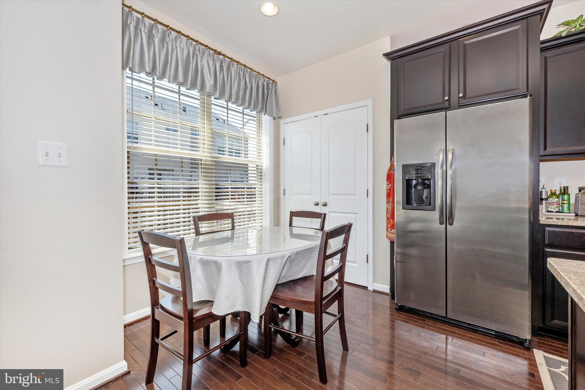 4731 Verdana Loop Frederick, MD 21703 - Photo 17 of 51 a view of a dining room with furniture window and wooden floor