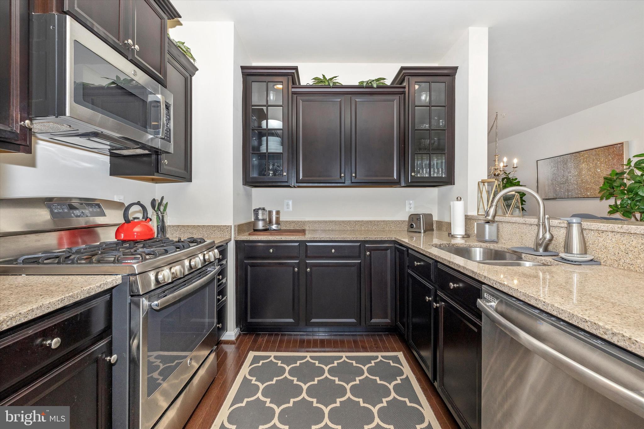 4731 Verdana Loop Frederick, MD 21703 - Photo 20 of 51 a kitchen with stainless steel appliances granite countertop a sink stove and cabinets