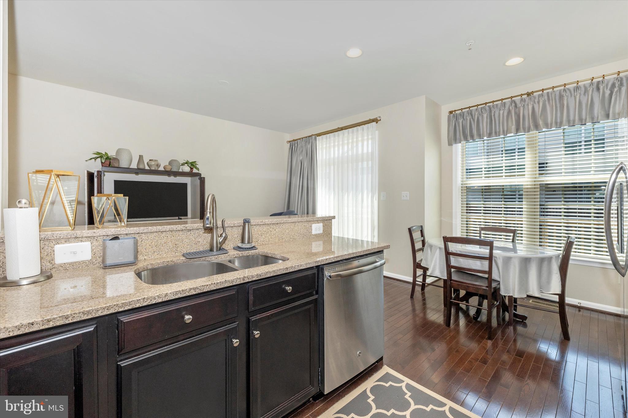 4731 Verdana Loop Frederick, MD 21703 - Photo 23 of 51 a kitchen with a table chairs sink and cabinets