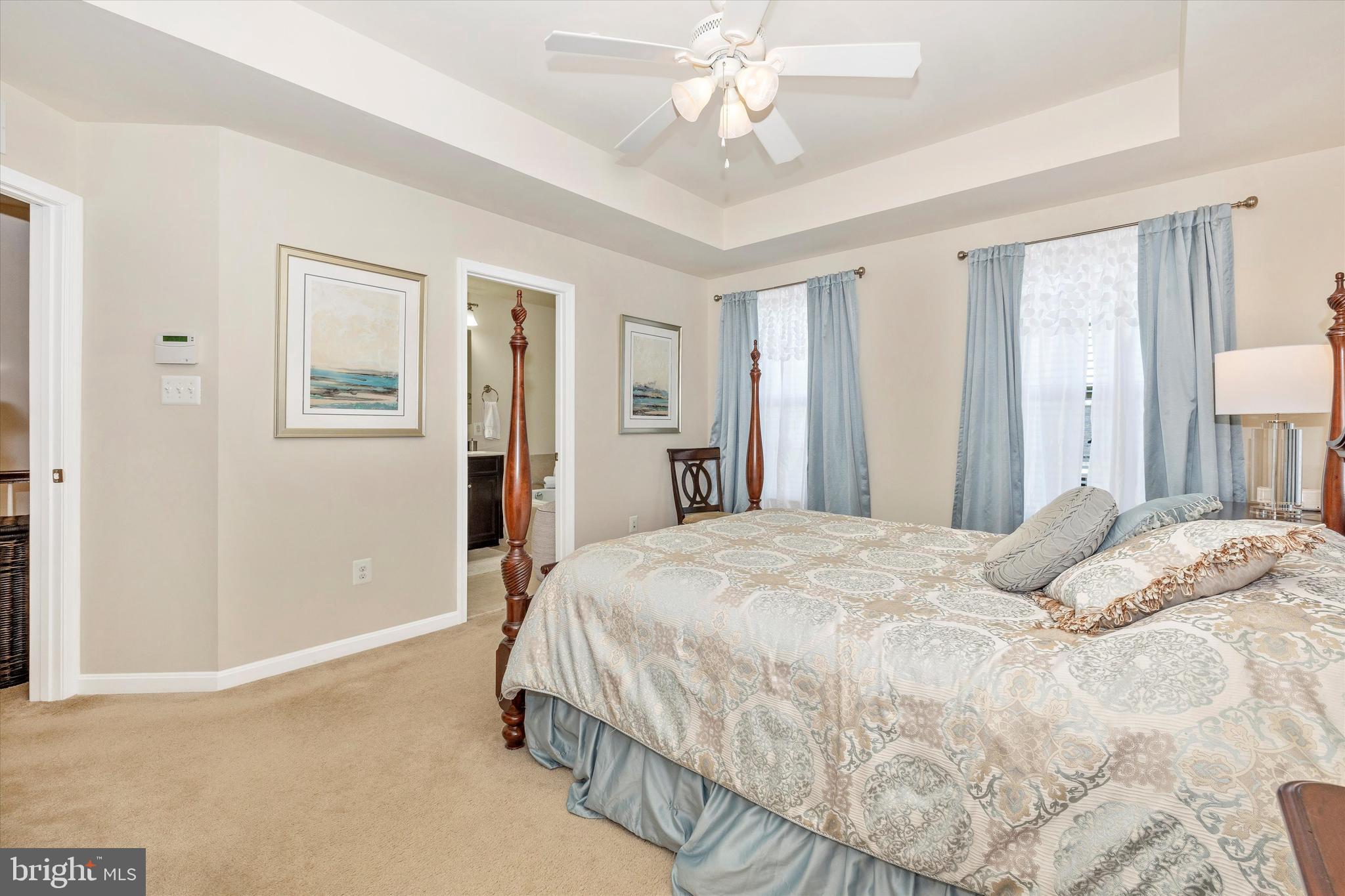 4731 Verdana Loop Frederick, MD 21703 - Photo 28 of 51 a bedroom with a large bed and a chandelier