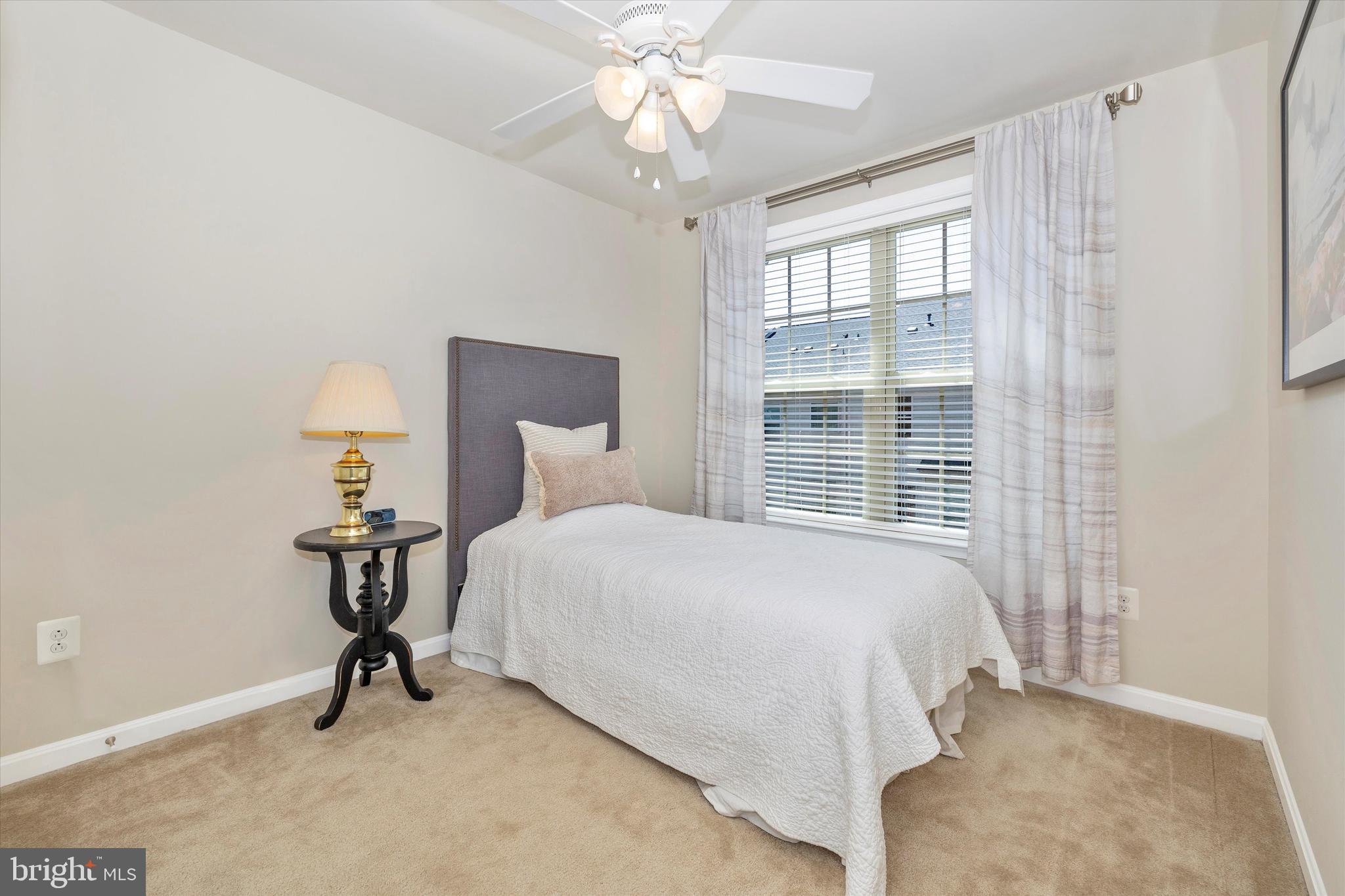 4731 Verdana Loop Frederick, MD 21703 - Photo 33 of 51 a bedroom with a bed and a chandelier