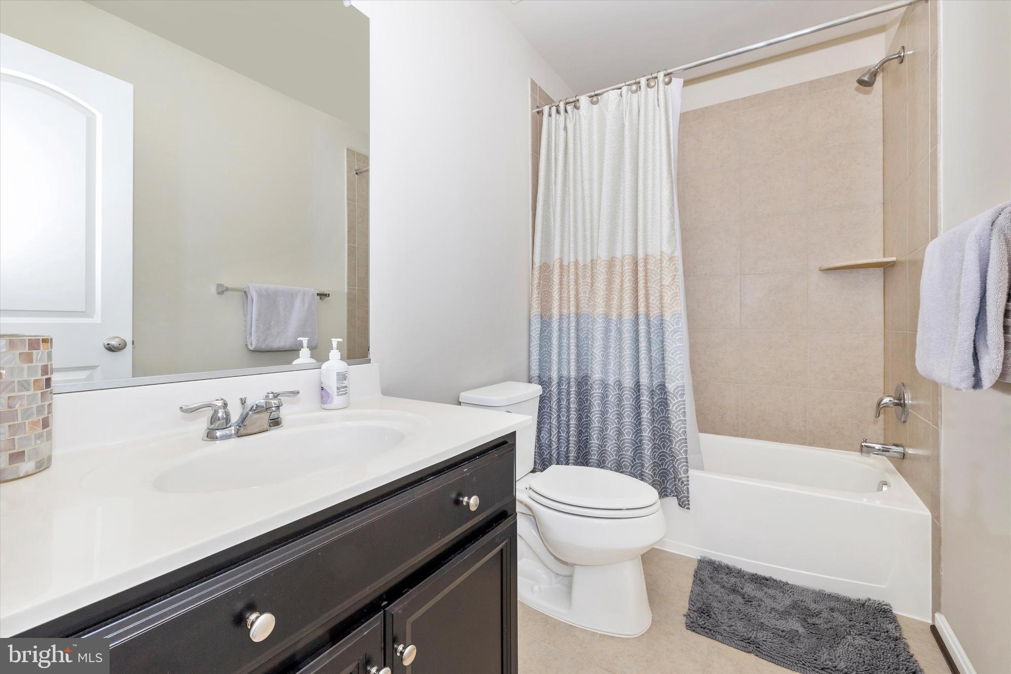 4731 Verdana Loop Frederick, MD 21703 - Photo 36 of 51 a bathroom with a sink a toilet a mirror and shower