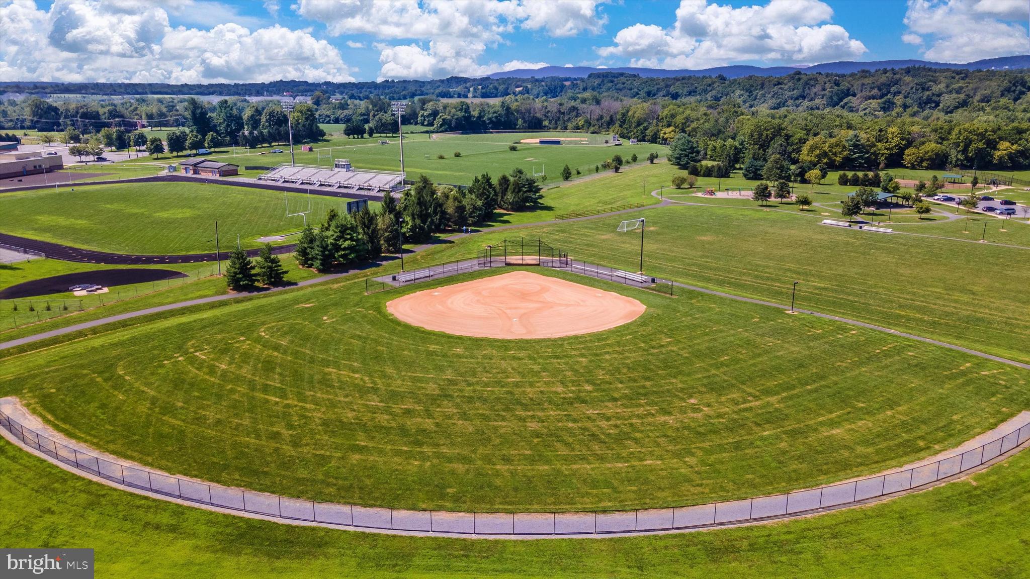 4731 Verdana Loop Frederick, MD 21703 - Photo 49 of 51 a view of a swimming pool with a yard and outdoor seating