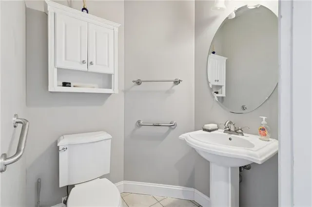 a bathroom with a sink toilet and mirror