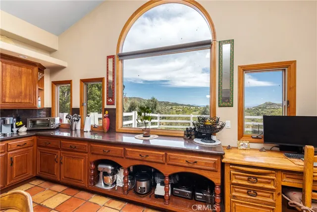a spacious bedroom with a bed a flat screen tv and a large window