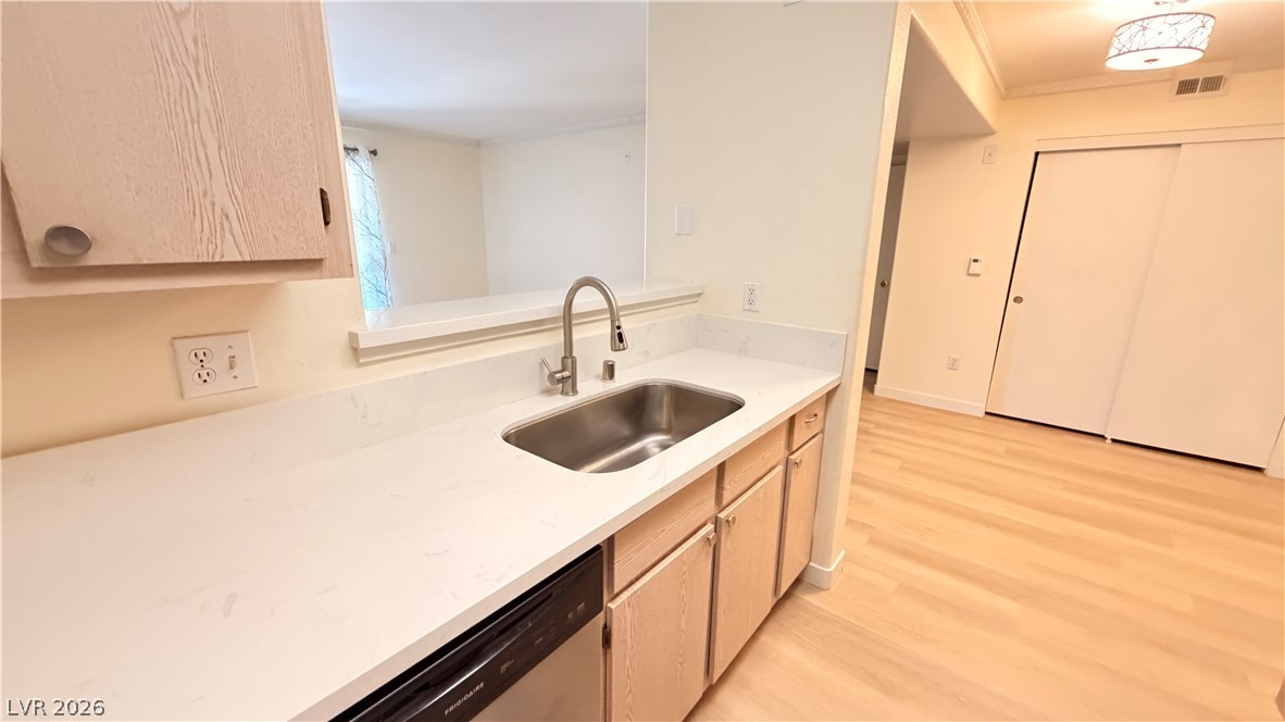 7885 West Flamingo Road, Unit 1131 Las Vegas, NV 89147 - Photo 20 of 36 A well-appointed kitchen features a stainless steel sink and light-toned cabinetry.