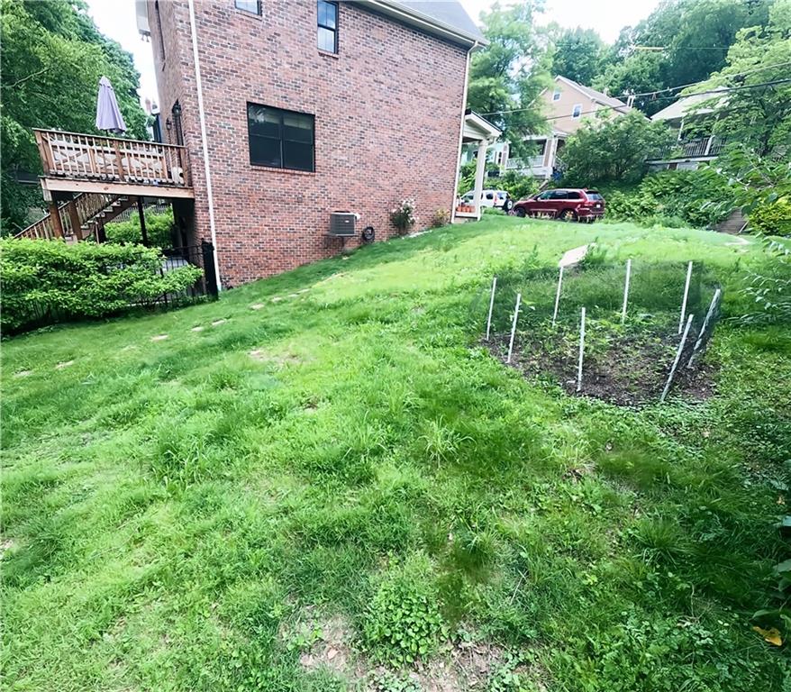 318 Garland Street Pittsburgh, PA 15218 - Photo 8 of 8 a view of a backyard with table and chairs potted plants and large tree