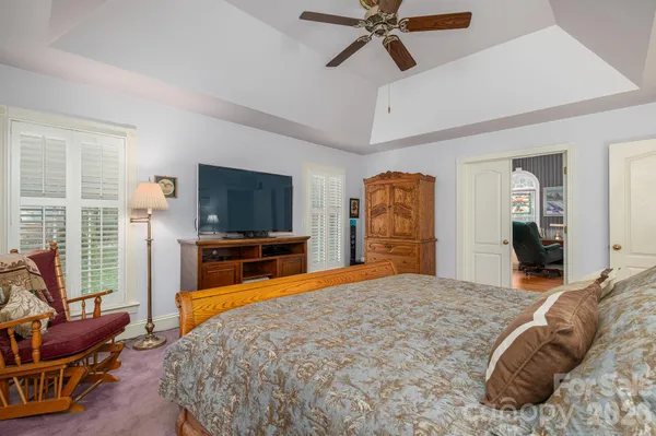 a bedroom with a bed and a television