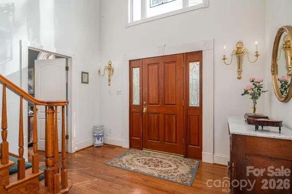 a view of an entryway with wooden floor