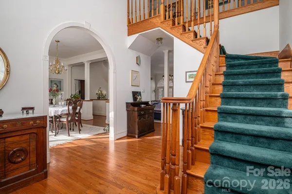 a view of entryway and hall with wooden floor