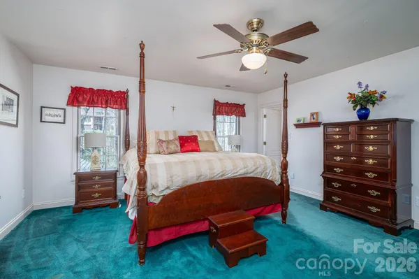 a bedroom with a bed closet and dresser