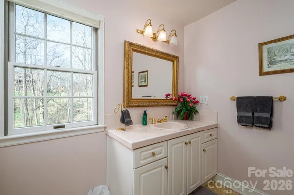 a bathroom with a sink mirror and vanity