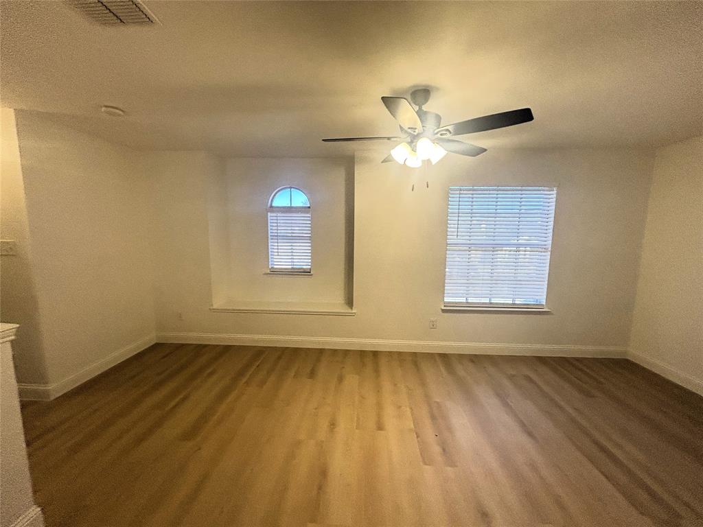 3112 Mason Avenue Corinth, TX 76210 - Photo 12 of 21 wooden floor in an empty room with a window