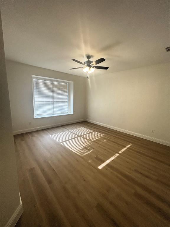 3112 Mason Avenue Corinth, TX 76210 - Photo 13 of 21 wooden floor in an empty room with a window