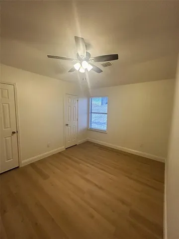 an empty room with windows and entrance