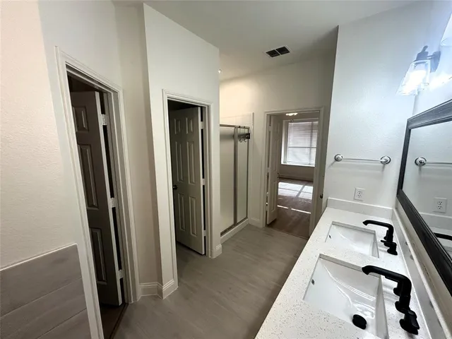 a bathroom with a double vanity sink and mirror