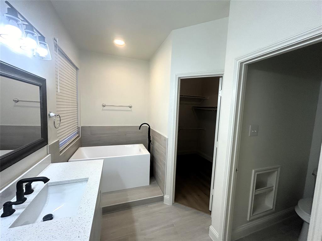 3112 Mason Avenue Corinth, TX 76210 - Photo 20 of 21 a bathroom with a sink a toilet and mirror
