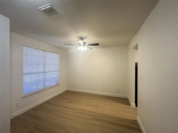 an empty room with wooden floor
