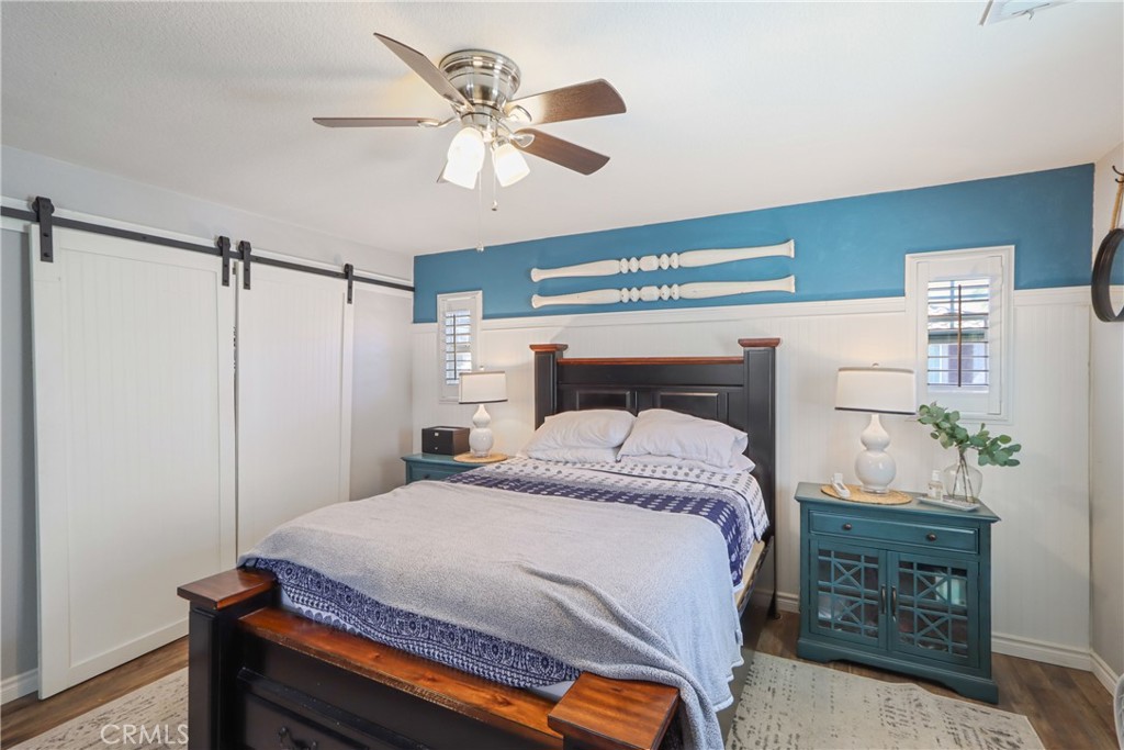 33971 Lily Road Yucaipa, CA 92399 - Photo 12 of 29 a bedroom with a bed and a chandelier