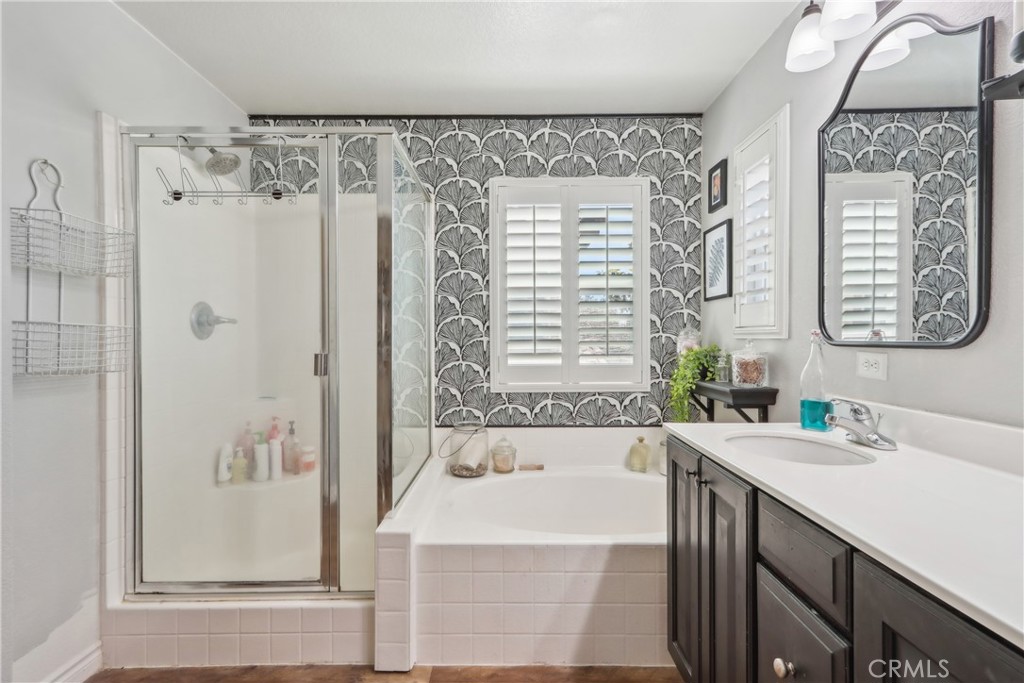 33971 Lily Road Yucaipa, CA 92399 - Photo 16 of 29 a bathroom with a bathtub a sink and a shower