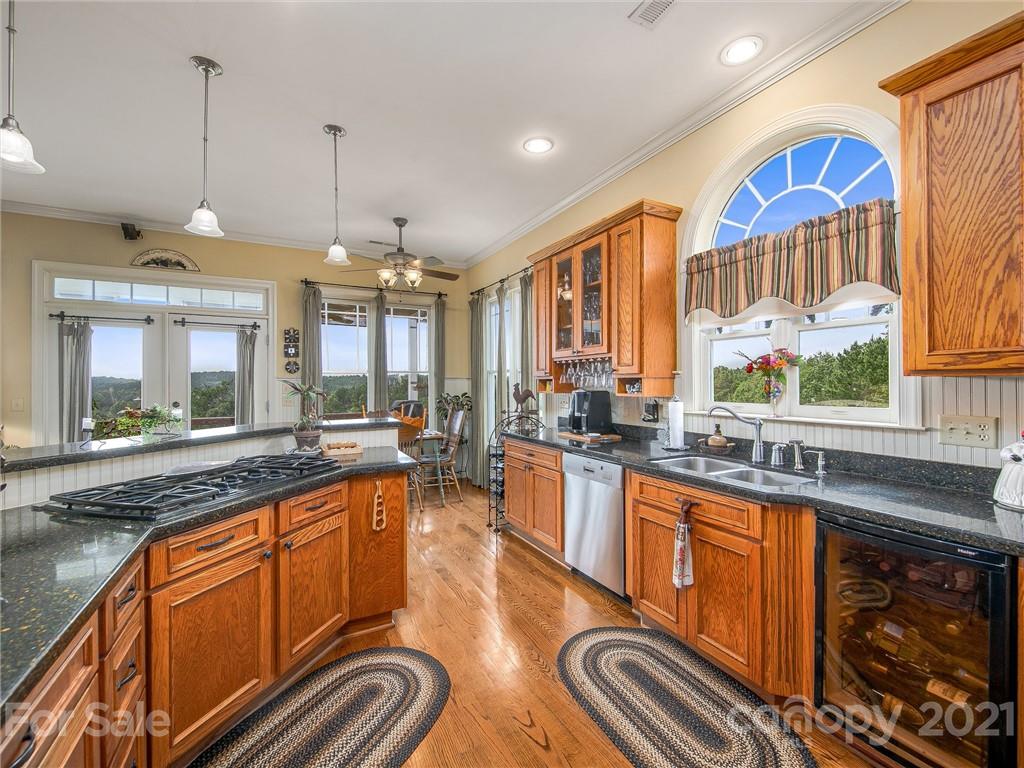 3043 John Watson Road Rutherfordton, NC 28139 - Photo 15 of 48 a large kitchen with stainless steel appliances granite countertop a sink and cabinets