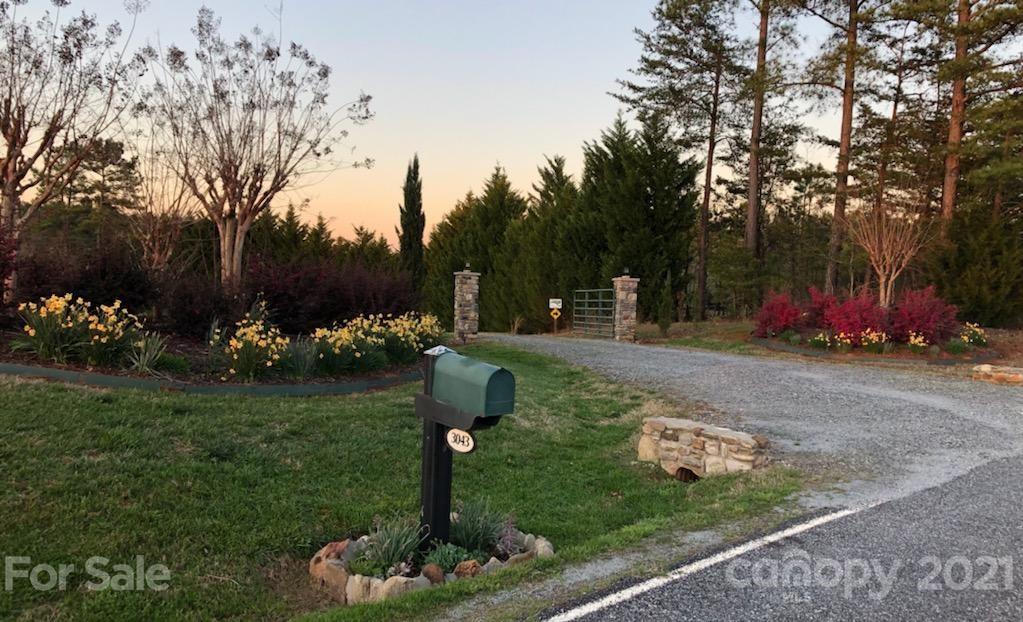 3043 John Watson Road Rutherfordton, NC 28139 - Photo 3 of 48 a front view of a house with garden and trees