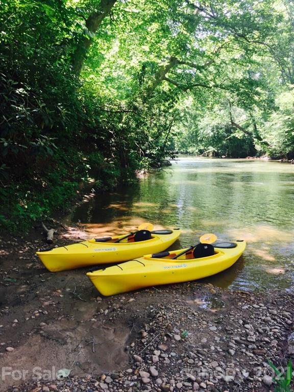 3043 John Watson Road Rutherfordton, NC 28139 - Photo 38 of 48 a view of a swimming pool with lawn chairs and wooden fence