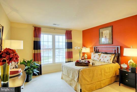 13773 Night Sky Drive Silver Spring, MD 20906 - Photo 2 of 20 a bed sitting in a bedroom next to a window