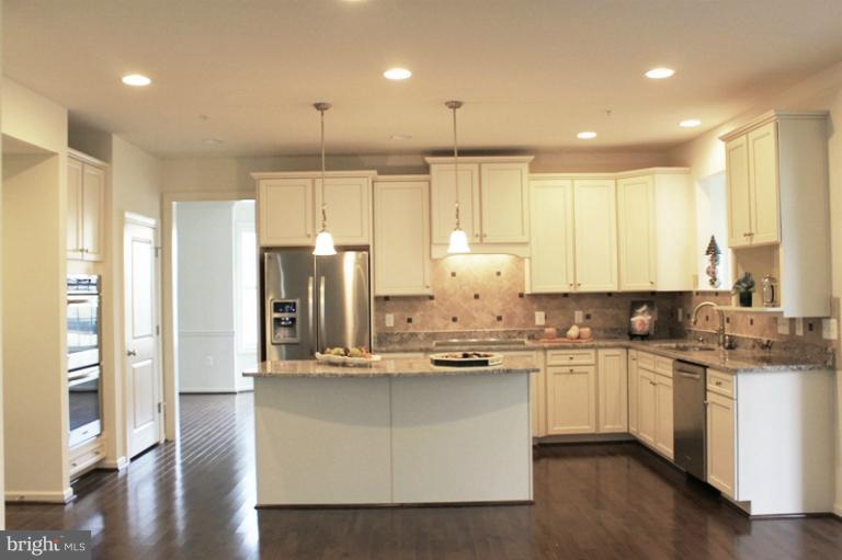 13773 Night Sky Drive Silver Spring, MD 20906 - Photo 12 of 20 a kitchen with stainless steel appliances granite countertop a sink a stove and refrigerator