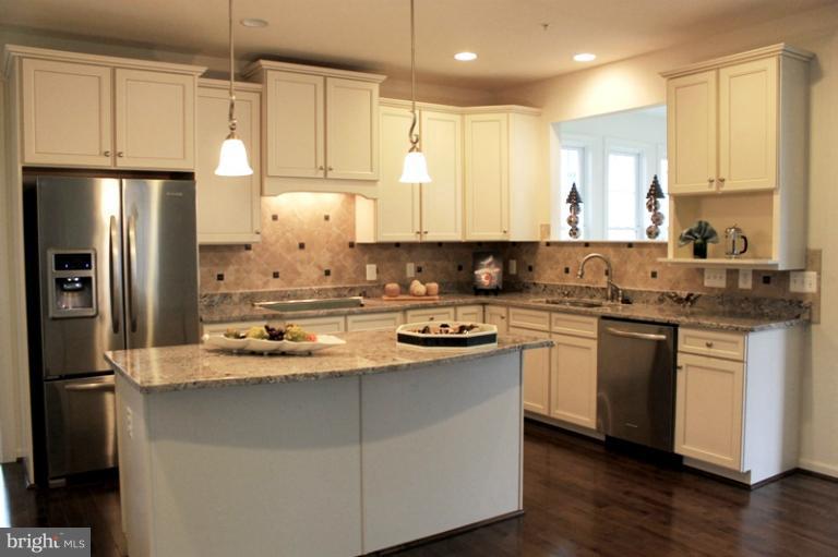 13773 Night Sky Drive Silver Spring, MD 20906 - Photo 16 of 20 a kitchen with stainless steel appliances granite countertop a sink stove and refrigerator