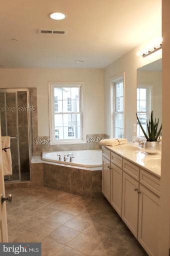 13773 Night Sky Drive Silver Spring, MD 20906 - Photo 17 of 20 a spacious bathroom with a granite countertop tub sink and mirror
