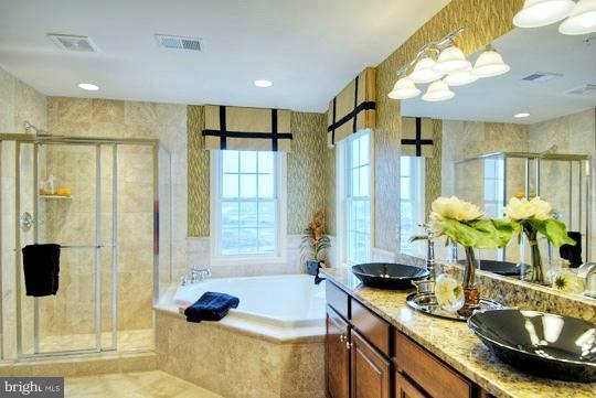 13773 Night Sky Drive Silver Spring, MD 20906 - Photo 10 of 20 a bathroom with a tub sink and mirror