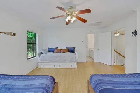 a bedroom with a large bed and a chandelier