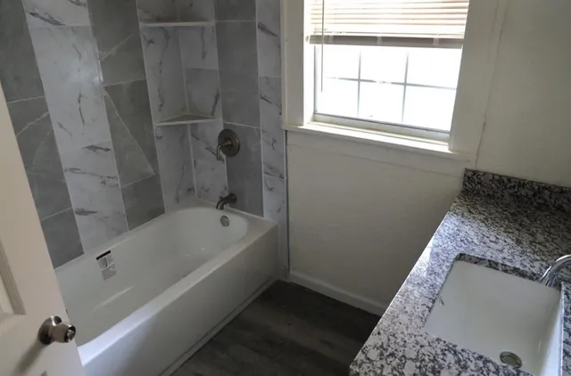 a bath tub sitting next to a window