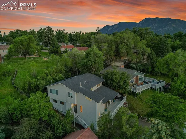 an aerial view of a house with mountain view