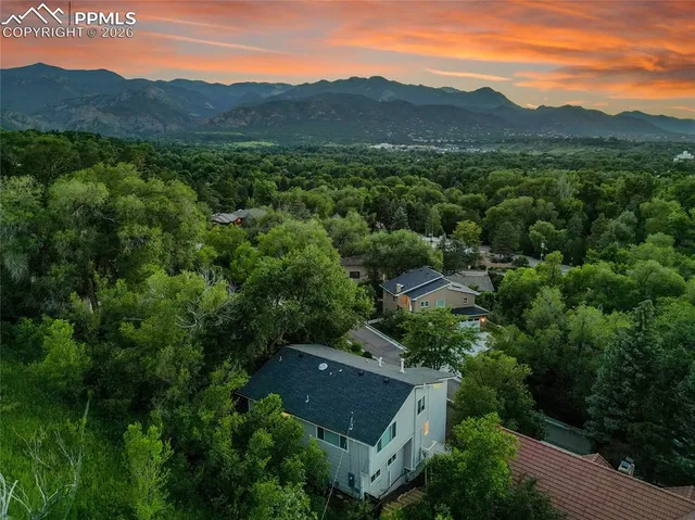 an aerial view of residential house with green space